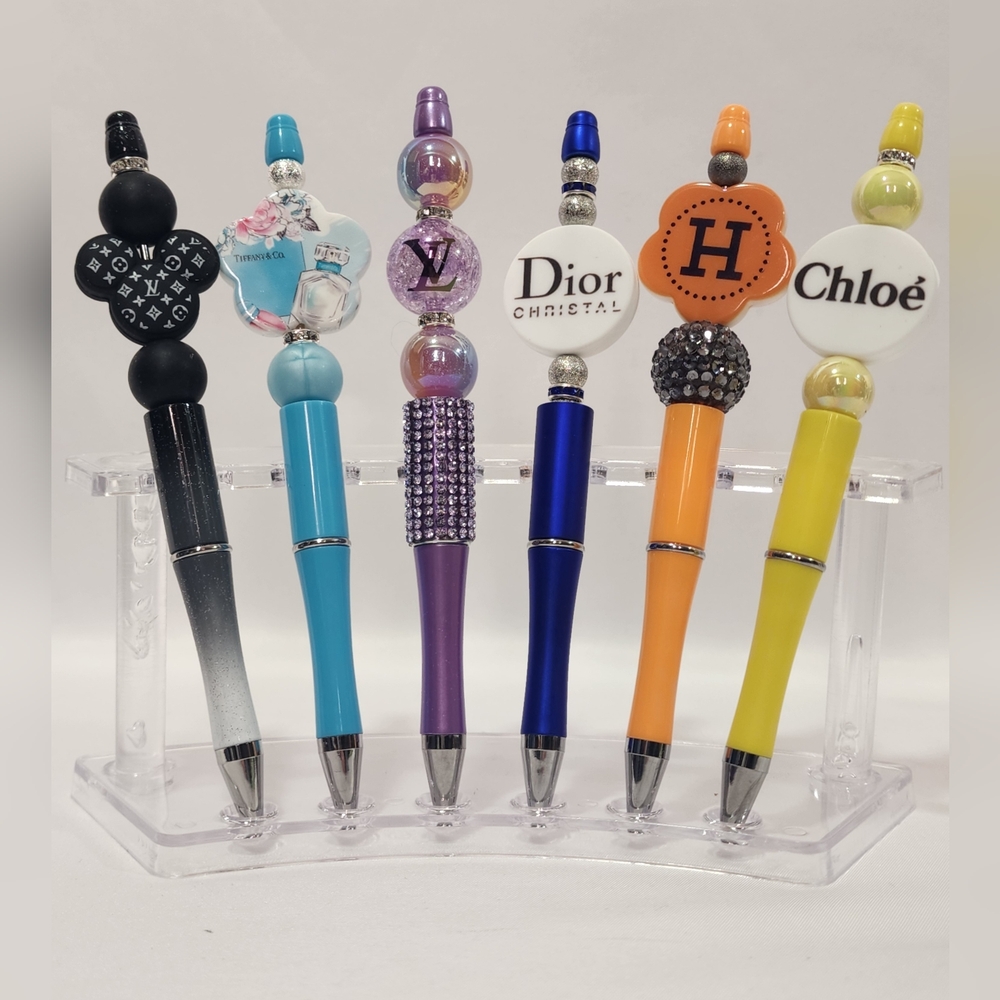 Decorative pens with designer-inspired logos Your Choice